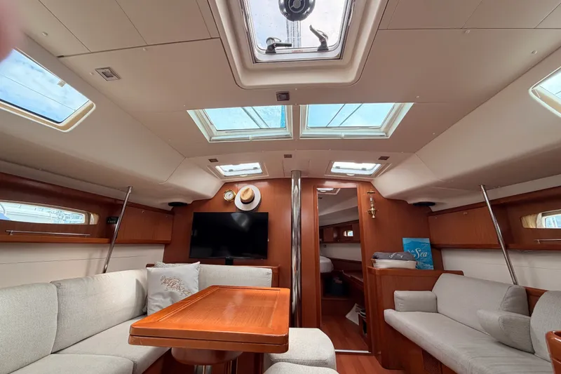Slide: The Image of Interior of a 2008 Beneteau 49 yacht with skylights and cozy seating area. - 63