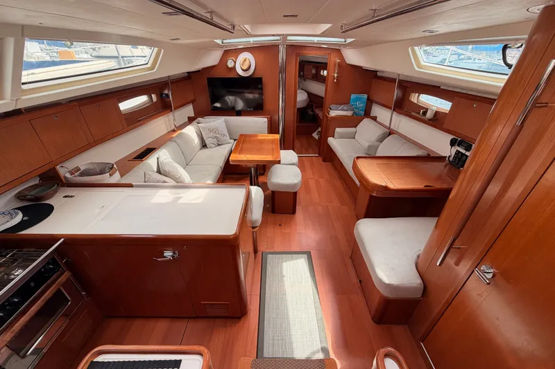 Slide: The Image of Luxurious interior of a 2008 Beneteau 49 yacht with elegant wood finishes and comfortable seating. - 40