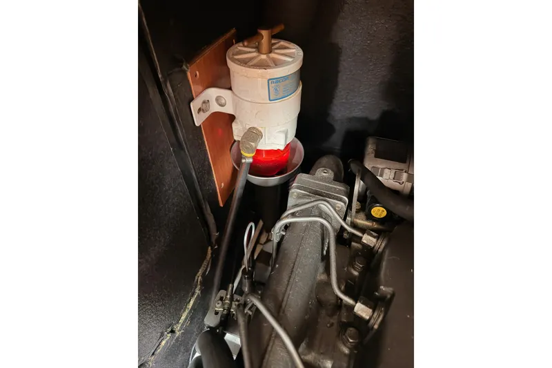 Slide: The Image of Engine compartment of a 2008 Beneteau 49 yacht, featuring a fuel filter system. - 84