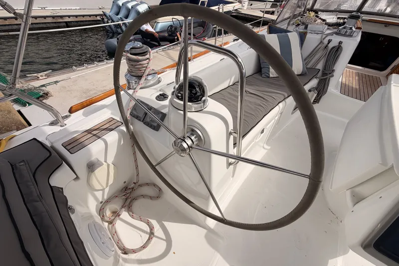 Slide: The Image of Cockpit of 2008 Beneteau 49 sailboat with steering wheel and nautical equipment. - 35