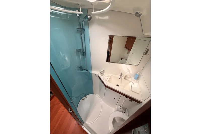 Slide: The Image of Compact bathroom in 2008 Beneteau 49 yacht with shower, sink, and toilet. - 68