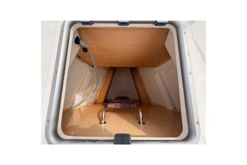 Slide: The Image of Storage compartment of a 2008 Beneteau 49 yacht, featuring a wooden interior and metal fittings. - 14
