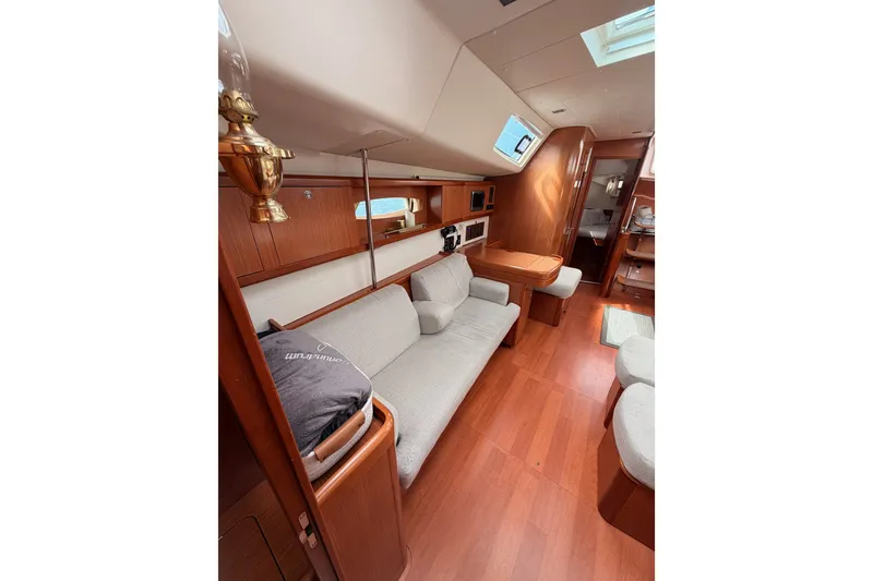Slide: The Image of Interior of a 2008 Beneteau 49 yacht, featuring elegant wood finishes and comfortable seating. - 70