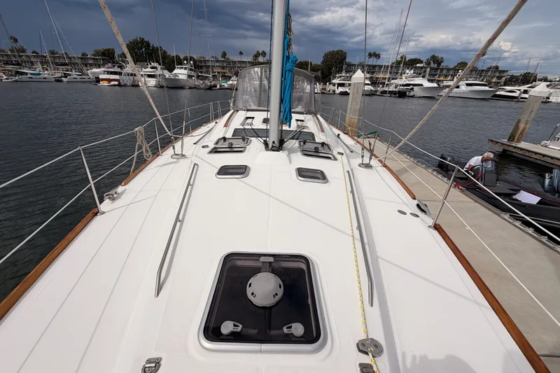 Slide: The Image of Deck view of a 2008 Beneteau 49 sailboat docked in a marina. - 19