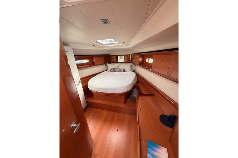 Slide: The Image of Luxurious cabin interior of 2008 Beneteau 49 yacht with wood finish and cozy bed. - 65