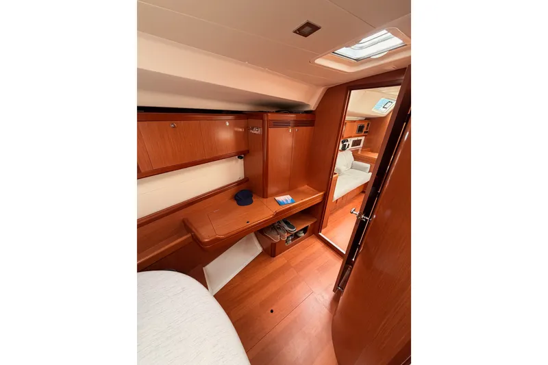 Slide: The Image of Interior of 2008 Beneteau 49 yacht with wooden cabinetry and cozy seating area. - 69