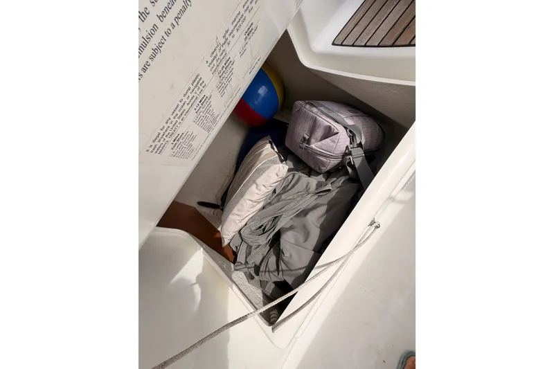 Slide: The Image of Storage compartment on a 2008 Beneteau 49 sailboat with bags and equipment. - 38