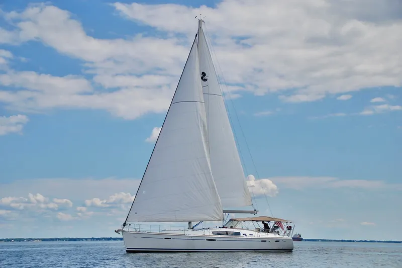 Slide: The Image of Sailing yacht Beneteau 49, 2008 model, cruising on calm waters under a blue sky. - 94