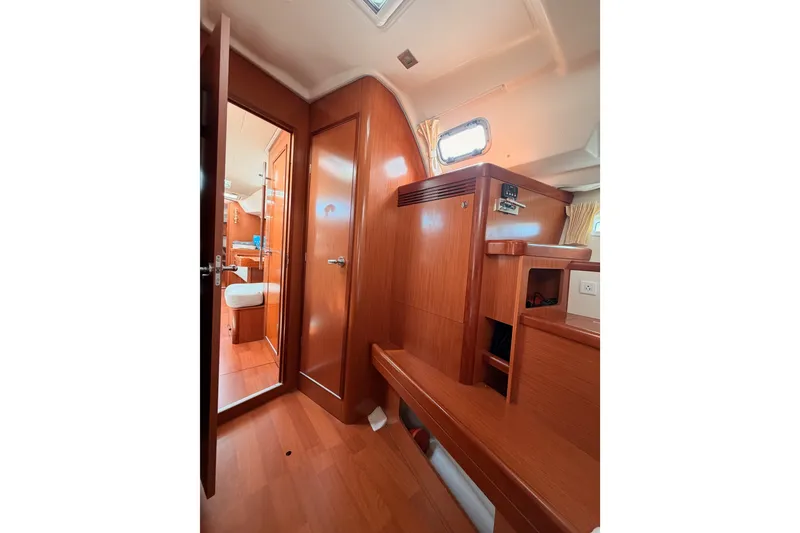 Slide: The Image of Interior of 2008 Beneteau 49 yacht, featuring wooden cabinetry and cozy cabin space. - 79