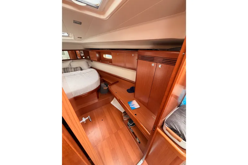 Slide: The Image of Interior of 2008 Beneteau 49 yacht cabin with wooden furnishings and cozy bed. - 64