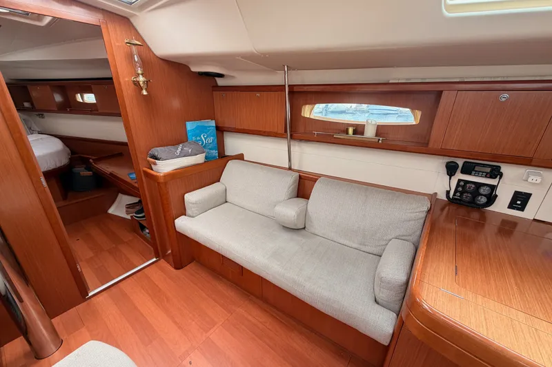 Slide: The Image of Interior of 2008 Beneteau 49 yacht with wooden finish and cozy seating area. - 60