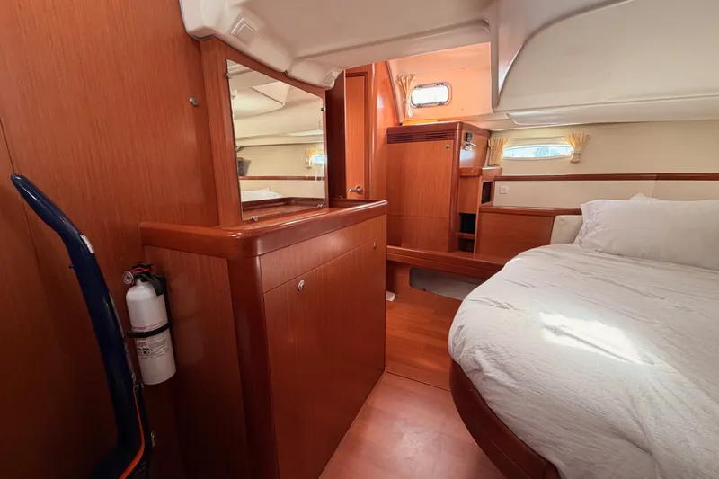Slide: The Image of Interior of 2008 Beneteau 49 yacht cabin with wooden furnishings and cozy bed. - 78