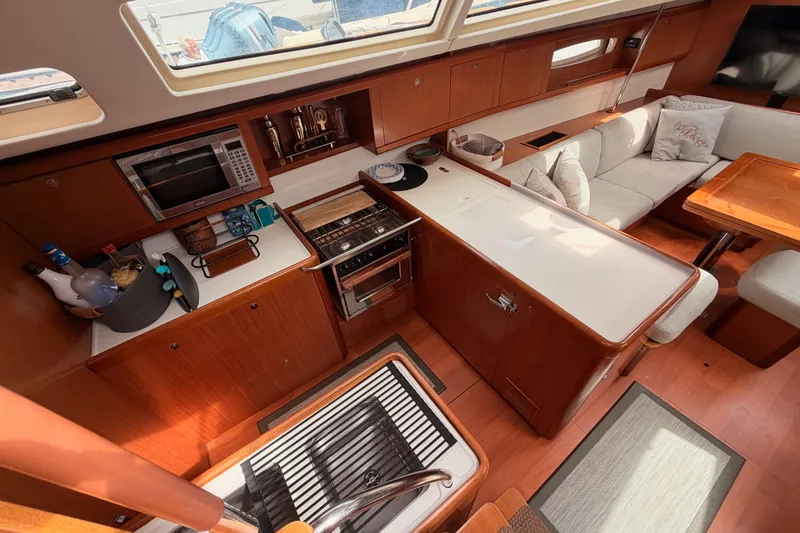 Slide: The Image of Luxurious interior of a 2008 Beneteau 49 yacht featuring a modern kitchen and cozy seating area. - 41