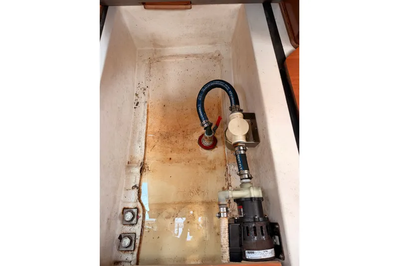 Slide: The Image of Bilge compartment of a 2008 Beneteau 49 sailboat with pump and hoses. - 90