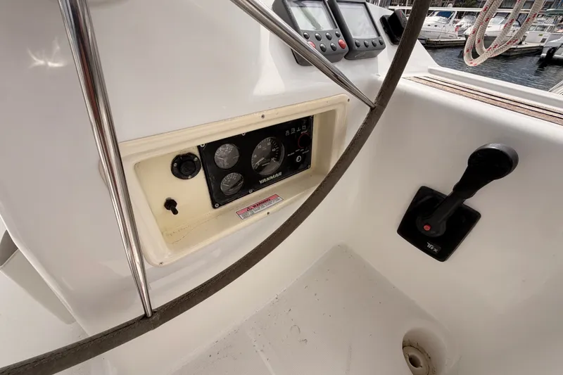 Slide: The Image of 2008 Beneteau 49 yacht helm with gauges and controls, docked at marina. - 33
