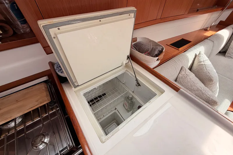 Slide: The Image of Open freezer in 2008 Beneteau 49 yacht kitchen, showcasing interior storage space. - 46
