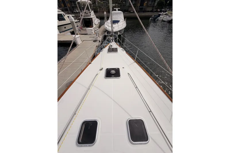 Slide: The Image of Deck view of a 2008 Beneteau 49 yacht docked at a marina. - 13
