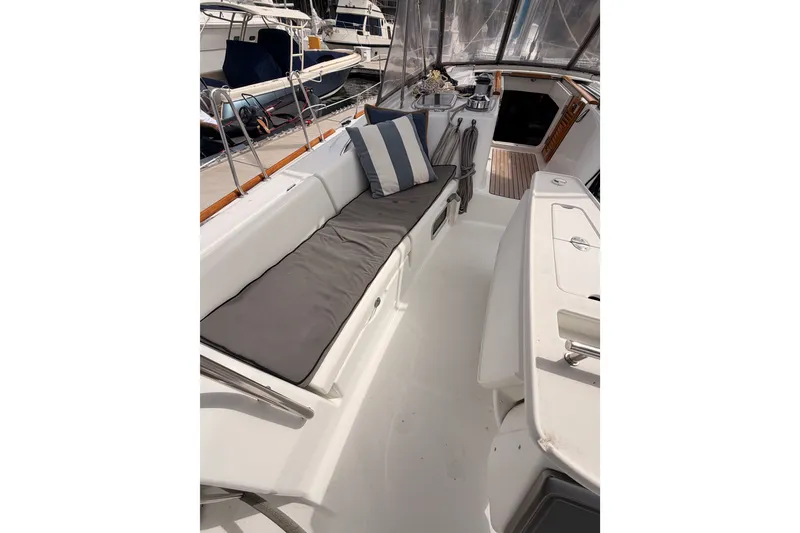 Slide: The Image of 2008 Beneteau 49 yacht cockpit with cushioned seating and striped pillows. - 37