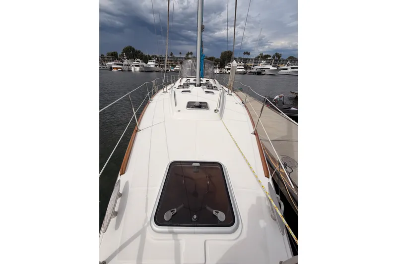 Slide: The Image of 2008 Beneteau 49 sailboat docked at marina under cloudy sky. - 18