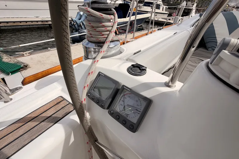 Slide: The Image of Cockpit of 2008 Beneteau 49 sailboat with navigation instruments and winch. - 36