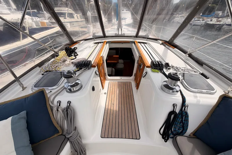 Slide: The Image of Cockpit of a 2008 Beneteau 49 sailboat with ropes and winches, docked in a marina. - 39