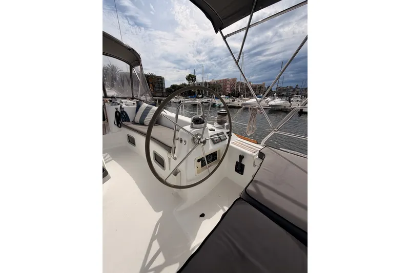 Slide: The Image of Cockpit of 2008 Beneteau 49 sailboat with steering wheel, marina view. - 29