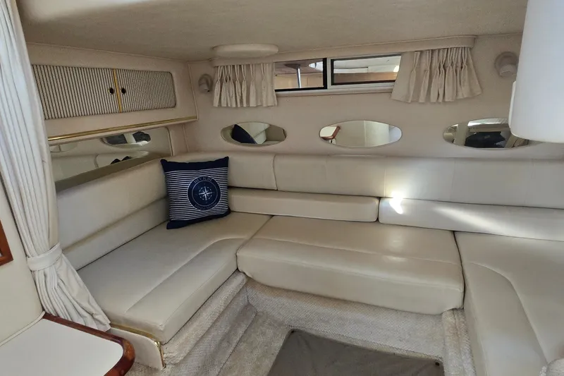 Slide: The Image of Interior of 2001 Sea Ray Sundancer 310 yacht with cream seating and nautical decor. - 21