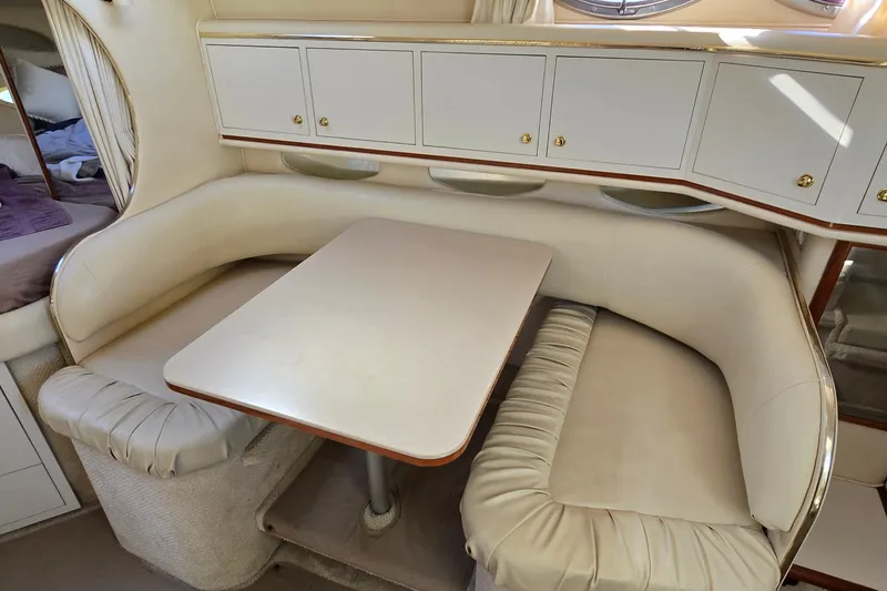 Slide: The Image of 2001 Sea Ray Sundancer 310 interior with cream leather seating and dining table. - 22