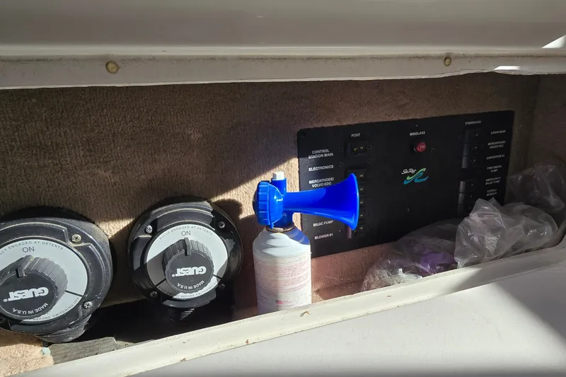 Slide: The Image of Control panel of a 2001 Sea Ray Sundancer 310 boat with switches and a blue air horn. - 16