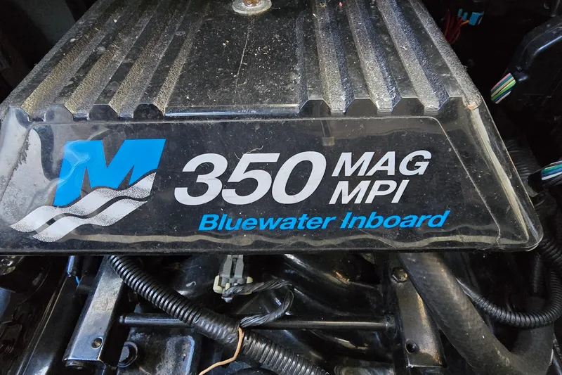 Slide: The Image of Engine cover of a 2001 Sea Ray Sundancer 310, featuring 350 MAG MPI Bluewater Inboard. - 39