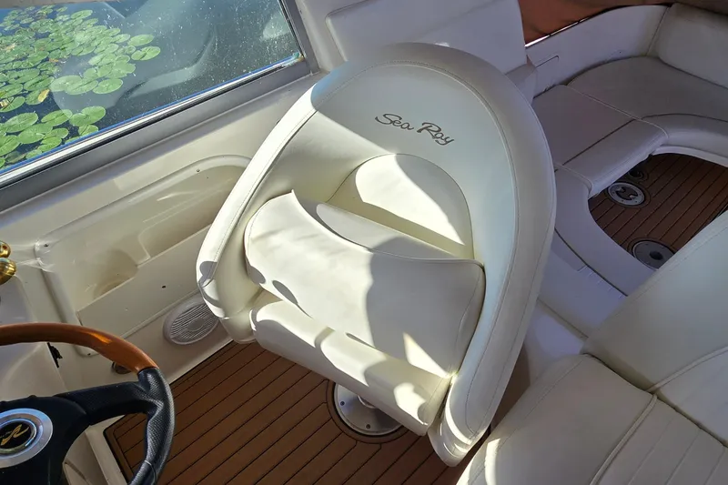 Slide: The Image of 2001 Sea Ray Sundancer 310 cockpit with white seating and wooden flooring. - 15