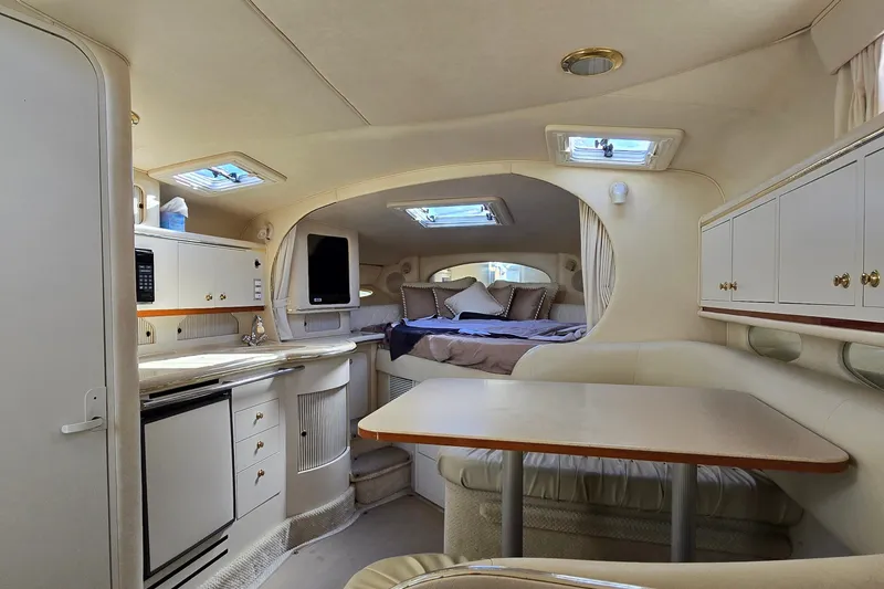Slide: The Image of Interior of 2001 Sea Ray Sundancer 310 yacht with cozy seating and kitchenette. - 31