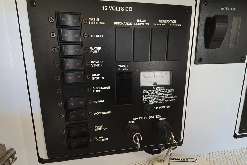 Slide: The Image of Control panel of a 2001 Sea Ray Sundancer 310 boat with various switches and gauges. - 33