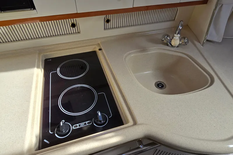 Slide: The Image of 2001 Sea Ray Sundancer 310 kitchen with stove and sink. - 27