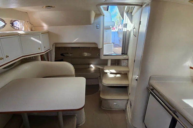 Slide: The Image of Interior of 2001 Sea Ray Sundancer 310 yacht with dining area and steps to deck. - 35
