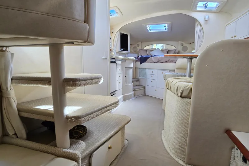 Slide: The Image of Interior of a 2001 Sea Ray Sundancer 310 yacht, featuring cozy seating and elegant design. - 32