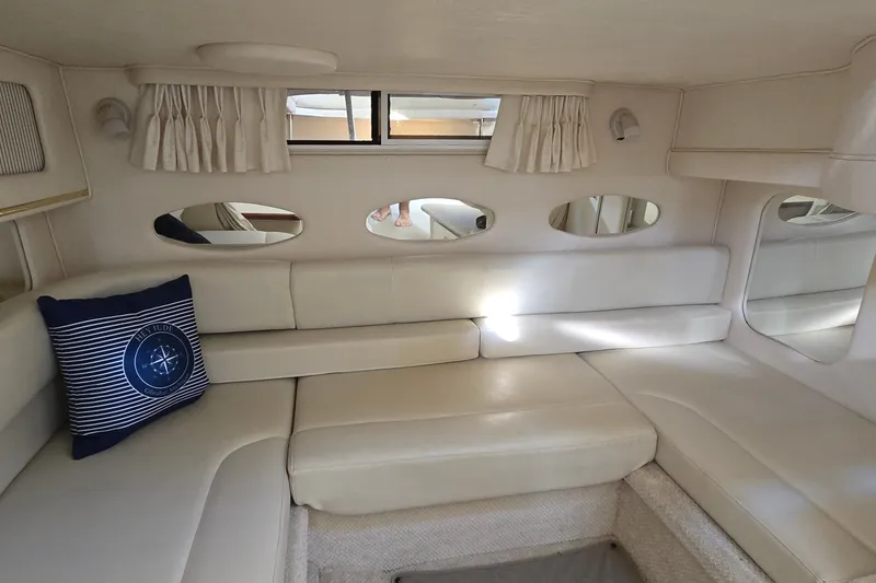 Slide: The Image of Interior of 2001 Sea Ray Sundancer 310 with cream leather seating and nautical decor. - 20