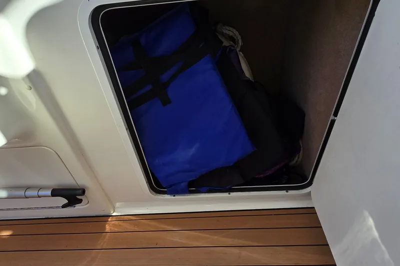 Slide: The Image of Storage compartment on a 2001 Sea Ray Sundancer 310 boat with blue life jackets. - 18