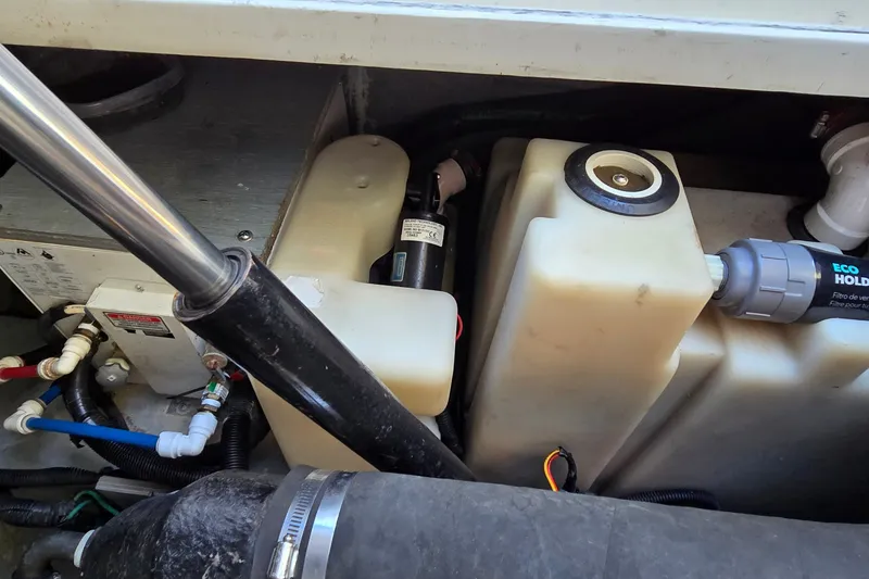 Slide: The Image of Engine compartment of a 2001 Sea Ray Sundancer 310, showing tanks and plumbing components. - 38