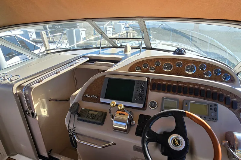 Slide: The Image of 2001 Sea Ray Sundancer 310 helm with navigation instruments and steering wheel. - 14