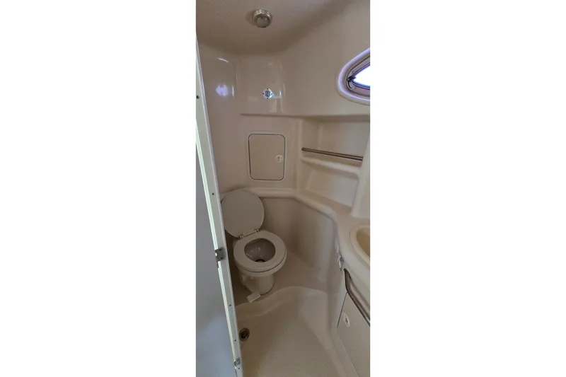 Slide: The Image of 2001 Sea Ray Sundancer 310 boat bathroom with toilet and compact design. - 29