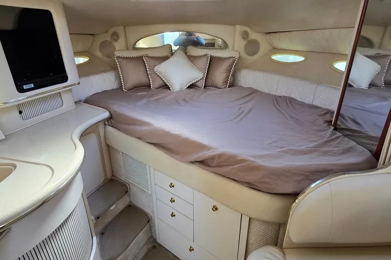 Slide: The Image of Interior cabin of 2001 Sea Ray Sundancer 310 with bed and storage. - 23