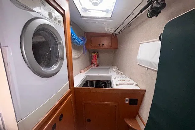 Slide: The Image of Laundry area inside a 2004 Manta 42 MkII yacht with washer and storage. - 18