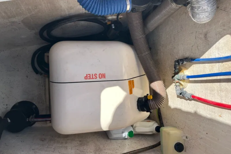 Slide: The Image of Engine compartment of a 2004 Manta 42 MkII with hoses and labeled tank. - 57