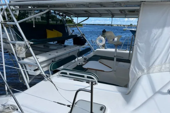 Slide: The Image of 2004 Manta 42 MkII catamaran with spacious deck and seating, docked by the water. - 15