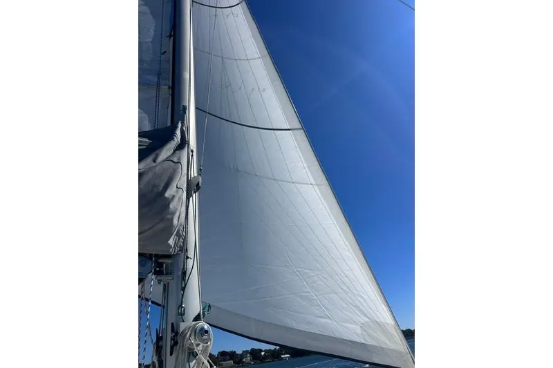 Slide: The Image of Sail of a 2004 Manta 42 MkII catamaran against a clear blue sky. - 70