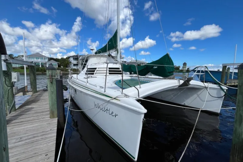 Slide: The Image of 2004 Manta 42 MkII catamaran docked under a clear blue sky. - 2
