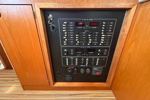 Slide: The Image of Electrical panel of a 2004 Manta 42 MkII yacht, featuring various switches and controls. - 24