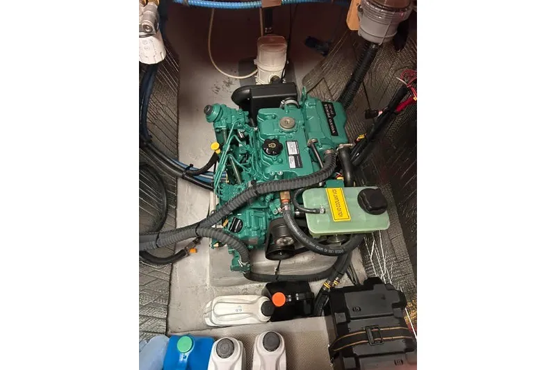 Slide: The Image of Engine compartment of a 2004 Manta 42 MkII sailboat, featuring a green marine engine. - 40