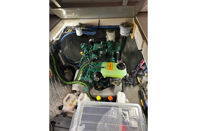 Slide: The Image of Engine compartment of a 2004 Manta 42 MkII sailboat, featuring a green marine engine. - 41